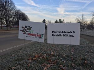 Signs  showing  the  NC4K  Reindeer  Run  logo  and  Presenting  Sponsor  Palermo-Edwards  &  Cacchillo  DDS,  Inc.